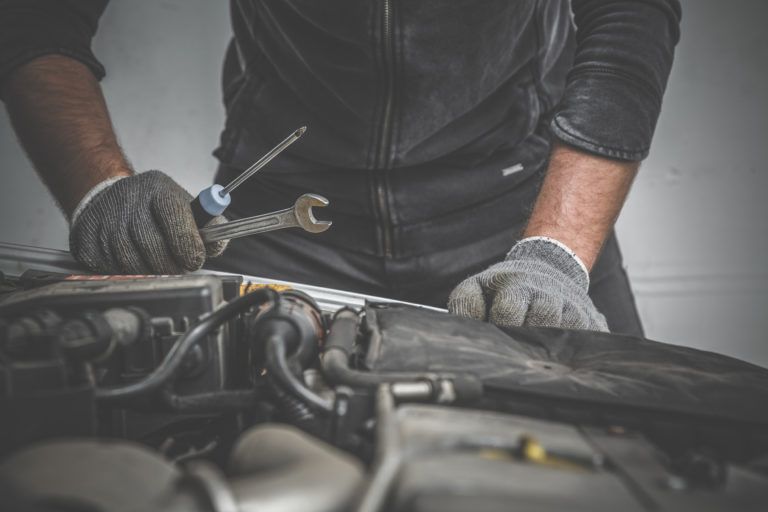 Professional Auto Mechanic Doing a Preventative Maintenance Check on a Vehicle