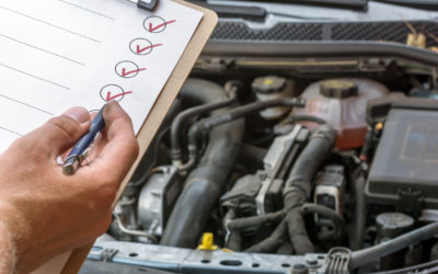 auto service expert checking off auto maintenance items on list